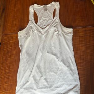 Gray/white striped body conscious, yet draped, workout top, Size M.